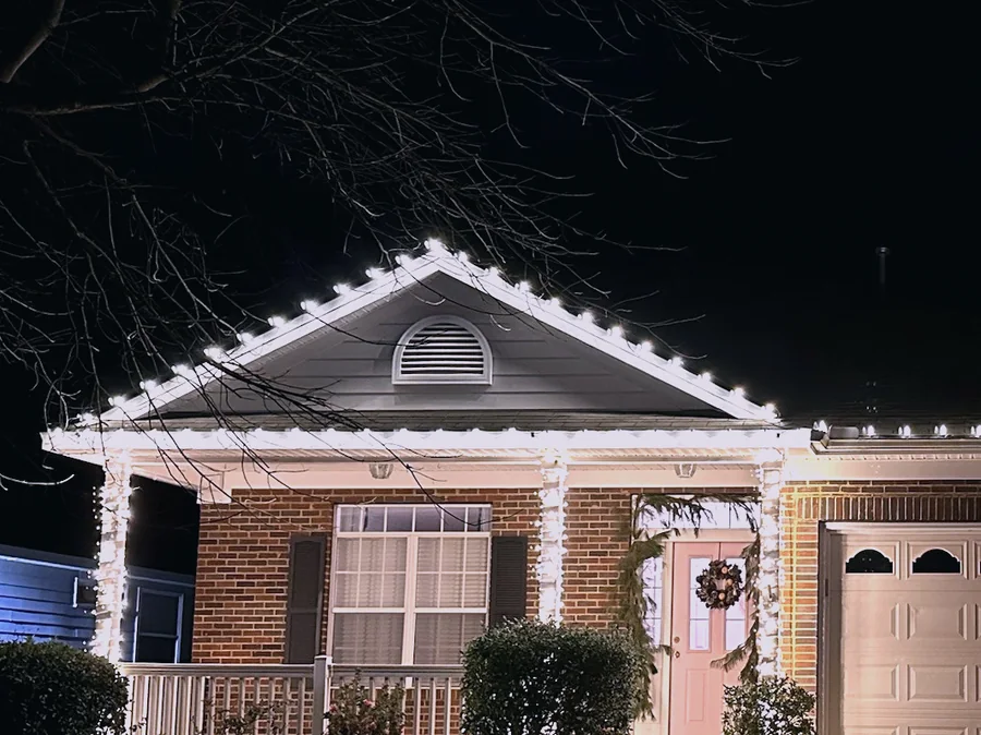 Warm white Christmas lights outlining a gable peak