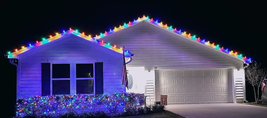Multicolor C9 Christmas lights along a roofline